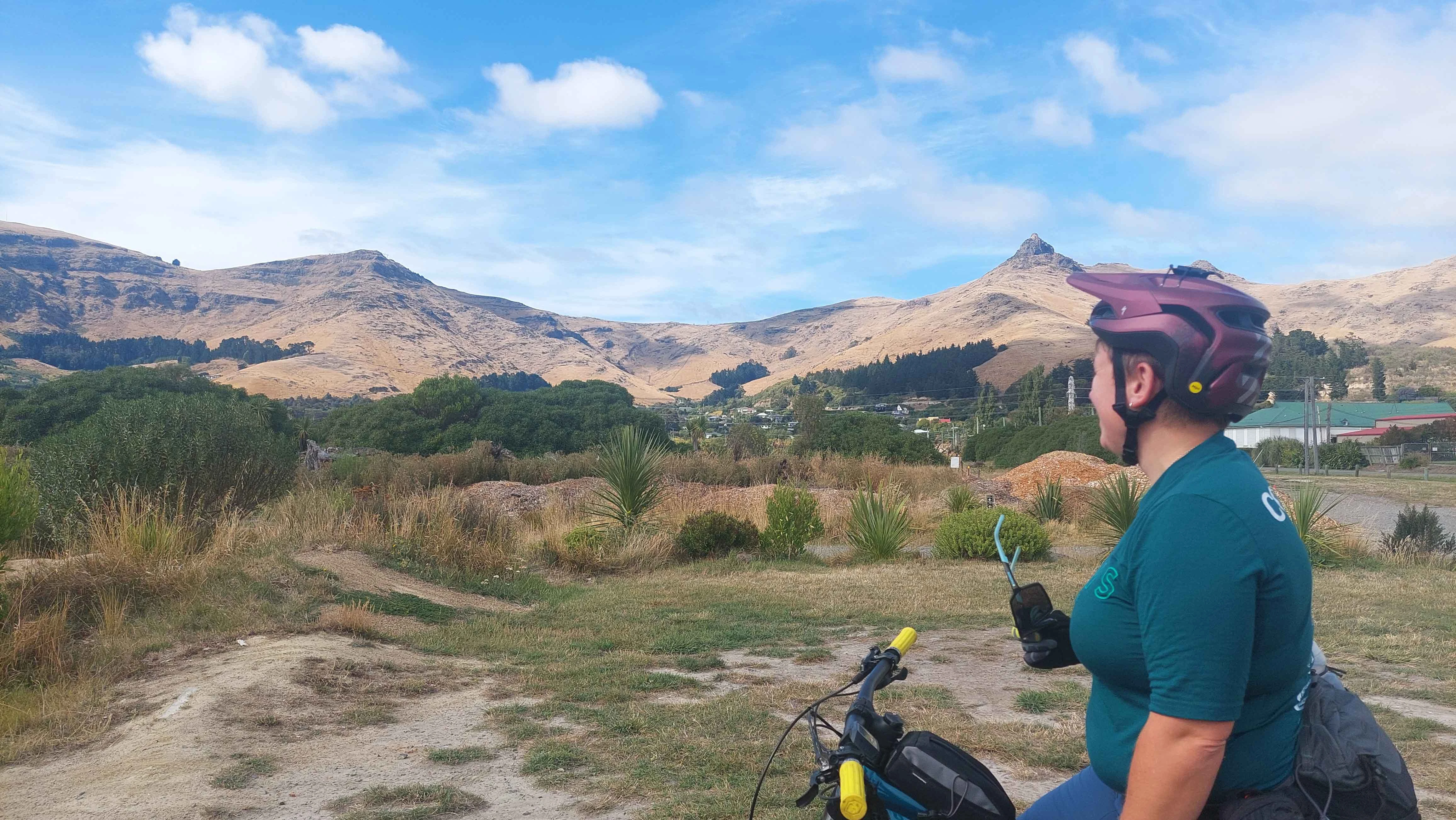 Rider wearing helmet in front of port hills